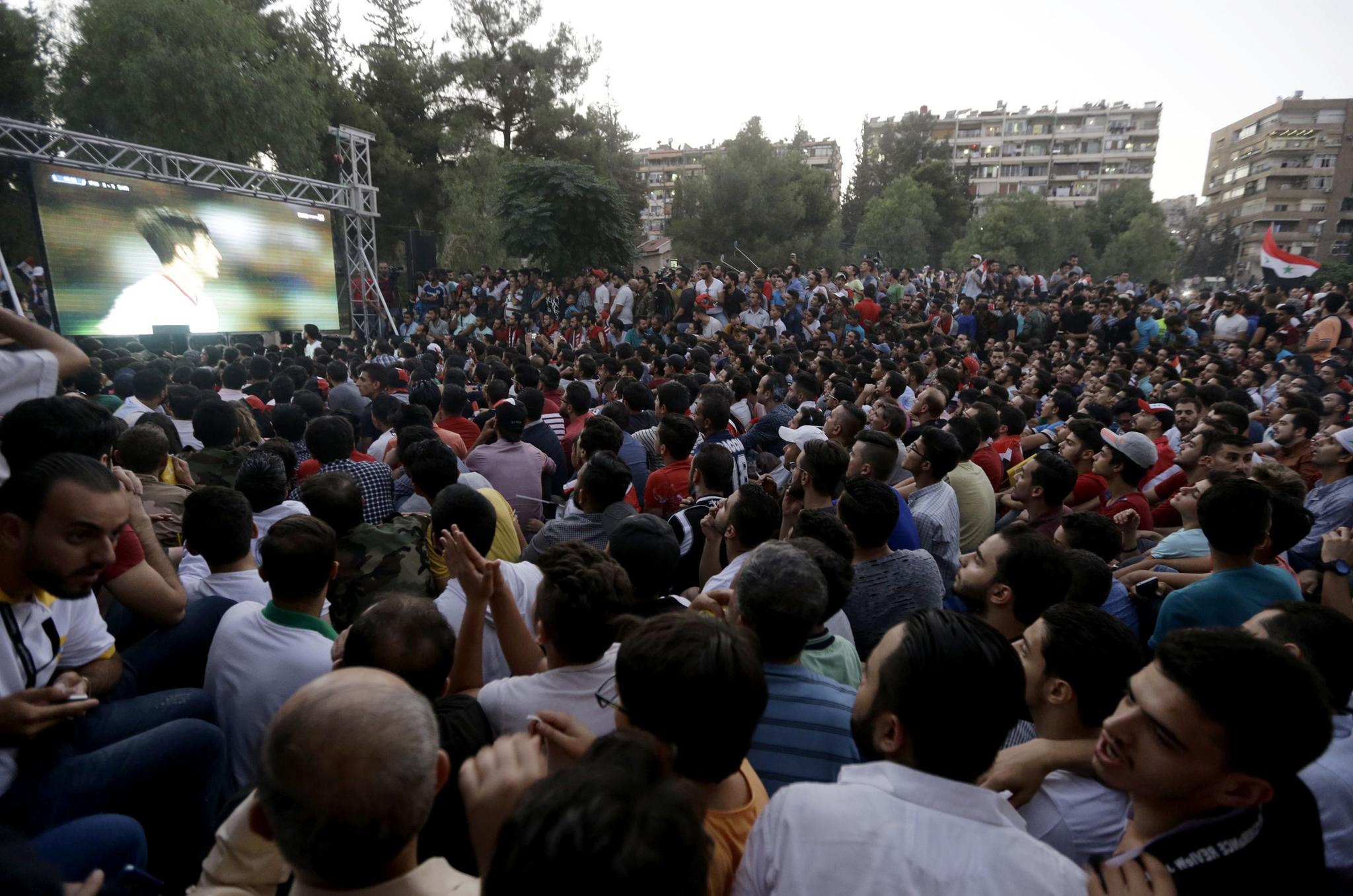 Crowd of Syrians watching World Cup qualifying match in Damascus